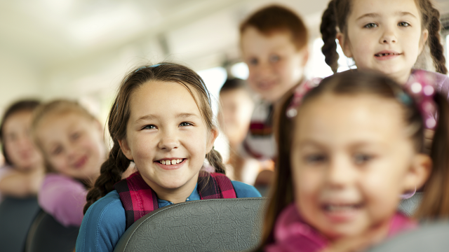 photo of school children on a school bus
