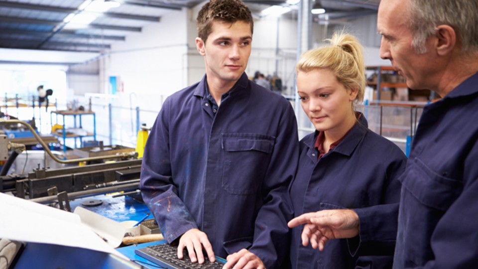 Young people with Adult in manufacturing factory