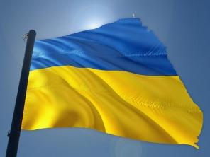 Flag of Ukraine, blowing in the wind against a sunny blue sky