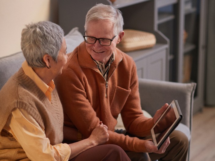 Couple looking at information on tablet device